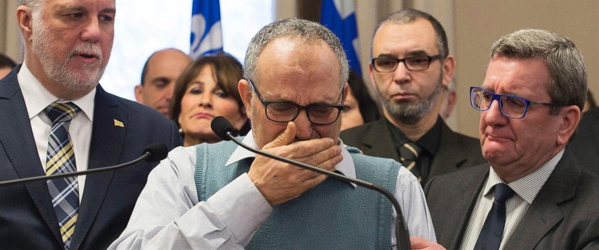 Centre culturel islamique de Québec vice-president Mohamed Labidi cries at a press conference with Quebec Premier Philippe Couillard, left, and Quebec City mayor Regis Labeaume, right (Jacques Boissinot / The Canadian Press).