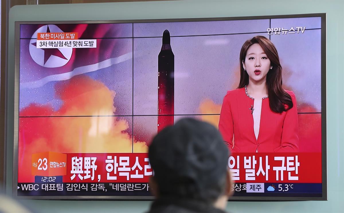 A man watches a TV news program reporting about North Korea’s missile launch with a file image of a North Korean missile at the Seoul Train Station in Seoul, South Korea. Sunday, Feb. 12, 2017. (AP Photo/Lee Jin-man)