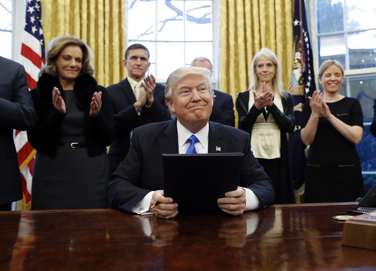 President Donald Trump smiles after signing three executive actions in the Oval Office, Saturday, Jan. 28, 2017 in Washington. (AP Photo/Alex Brandon)