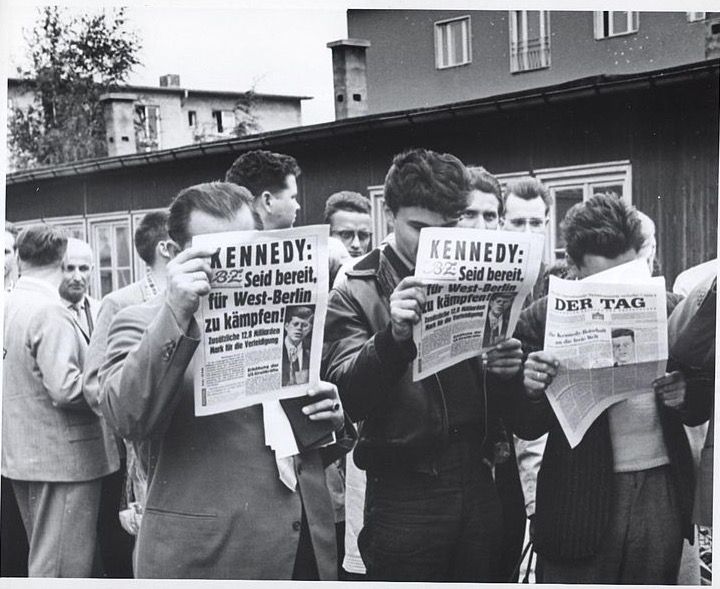 1961: East German refugees read of Kennedy’s address regarding the Berlin wall