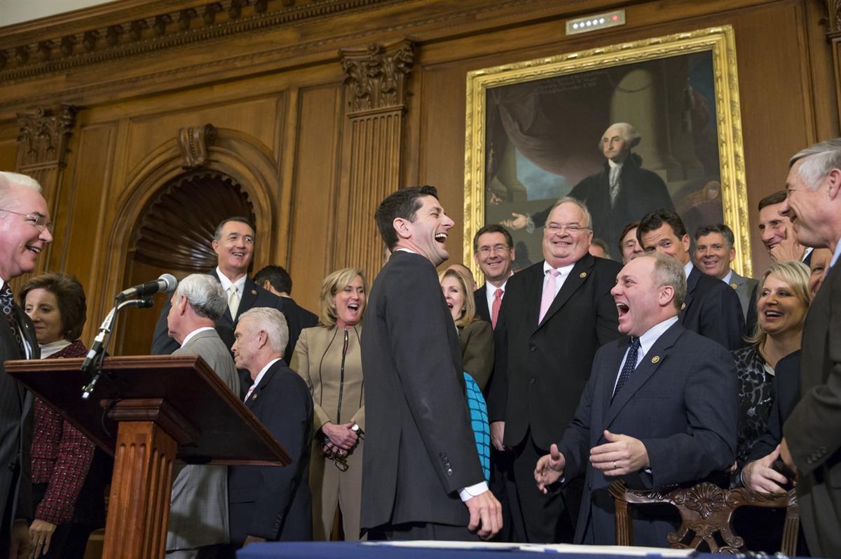 Speaker of the House Paul Ryan, R-Wis., left, laughs with Majority Whip Steve Scalise, R-La., center right, just after Ryan signed a bill designed to eliminate key parts of President Barack Obama’s health care law. Thursday, Jan. 7, 2016. (AP Photo/J. Scott Applewhite)