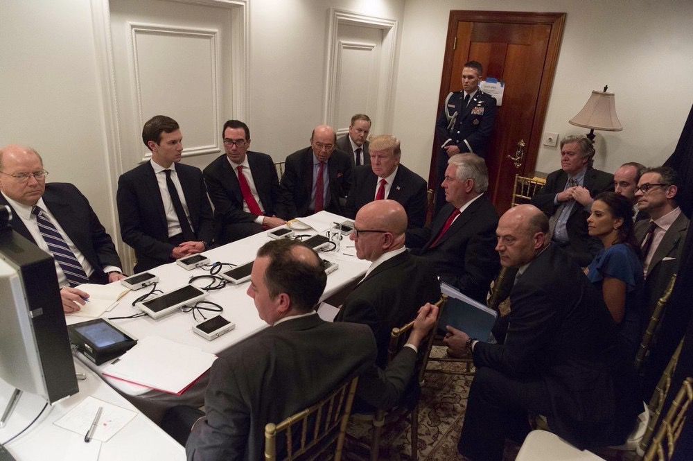 President Donald Trump receives a briefing on the Syria military strike from his National Security team after the strike at Mar-a-Lago in Palm Beach, Fla., Thursday night, April 6, 2017. (White House via AP)