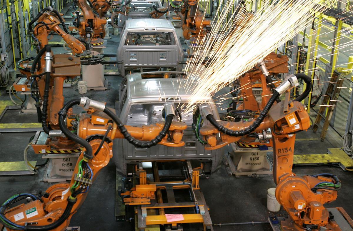 Assembly line robots weld the front cab of Chrysler’s 2009 Dodge Ram pickup in Warren, Michigan — Dec. 17, 2008 (AP Photo/Carlos Osorio, file)