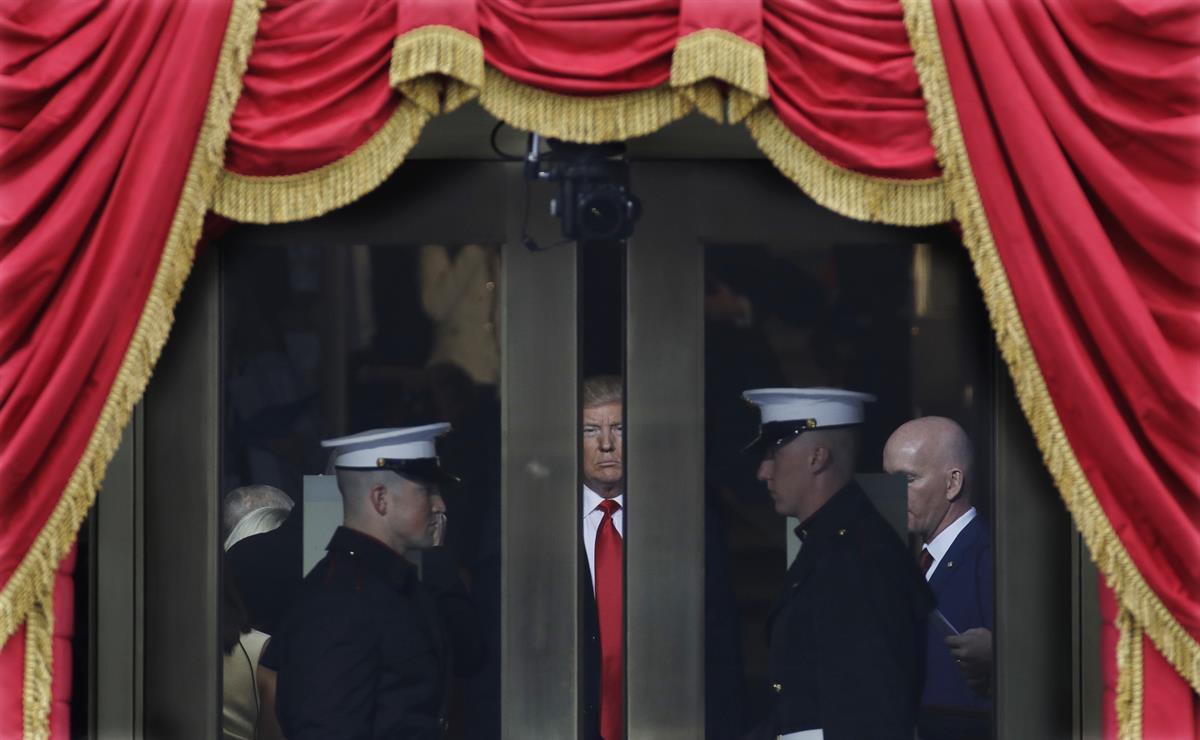 President Donald Trump waits to step out onto the portico for his Presidential Inauguration at the U.S. Capitol in Washington. Friday, Jan. 20, 2017. (AP Photo/Patrick Semansky)