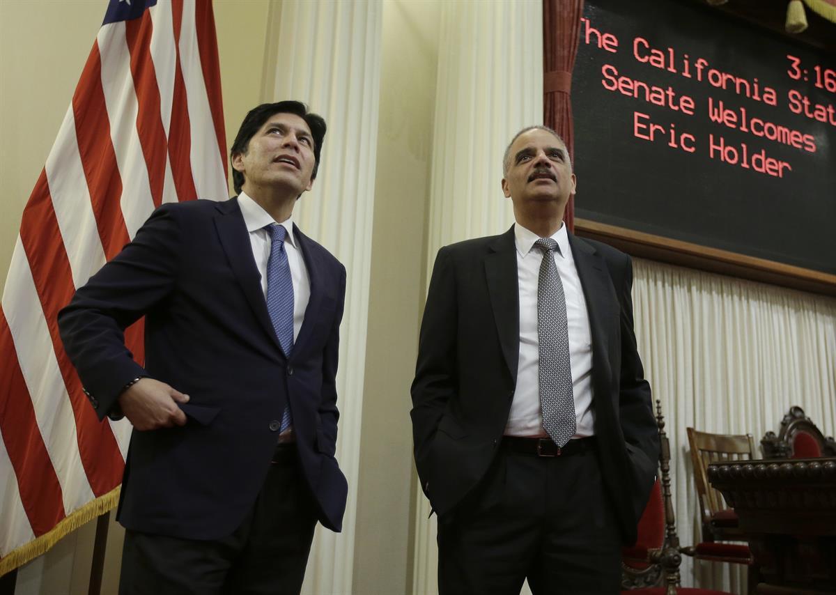 Former U.S. Attorney General Eric Holder, right, is given a tour of the state Senate chamber by Senate President Pro Tem Kevin de Leon, D-Los Angeles, Tuesday, Feb. 7, 2017, in Sacramento, Calif. (AP Photo/Rich Pedroncelli)