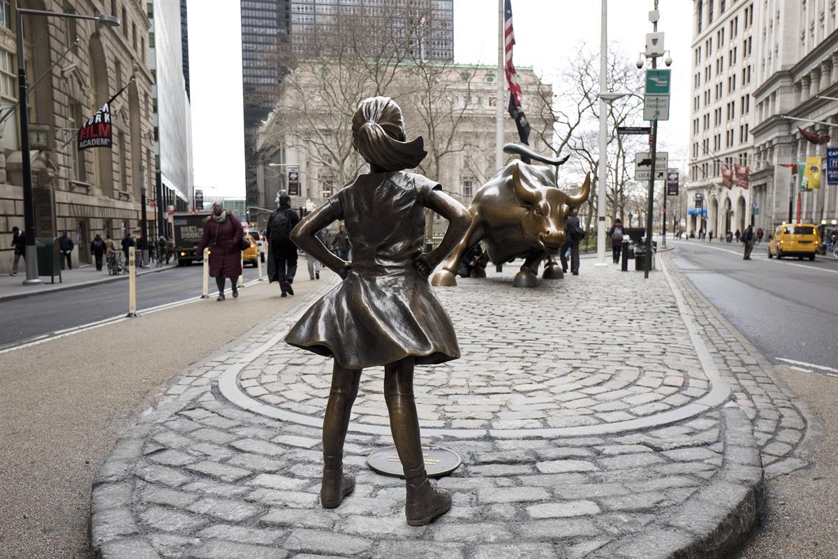 The “Fearless Girl” statue faces Wall Street’s charging bull statue, Wednesday, March 8, 2017, in New York. An inscription at the base reads, “Know the power of women in leadership. She makes a difference.” (AP Photo/Mark Lennihan)