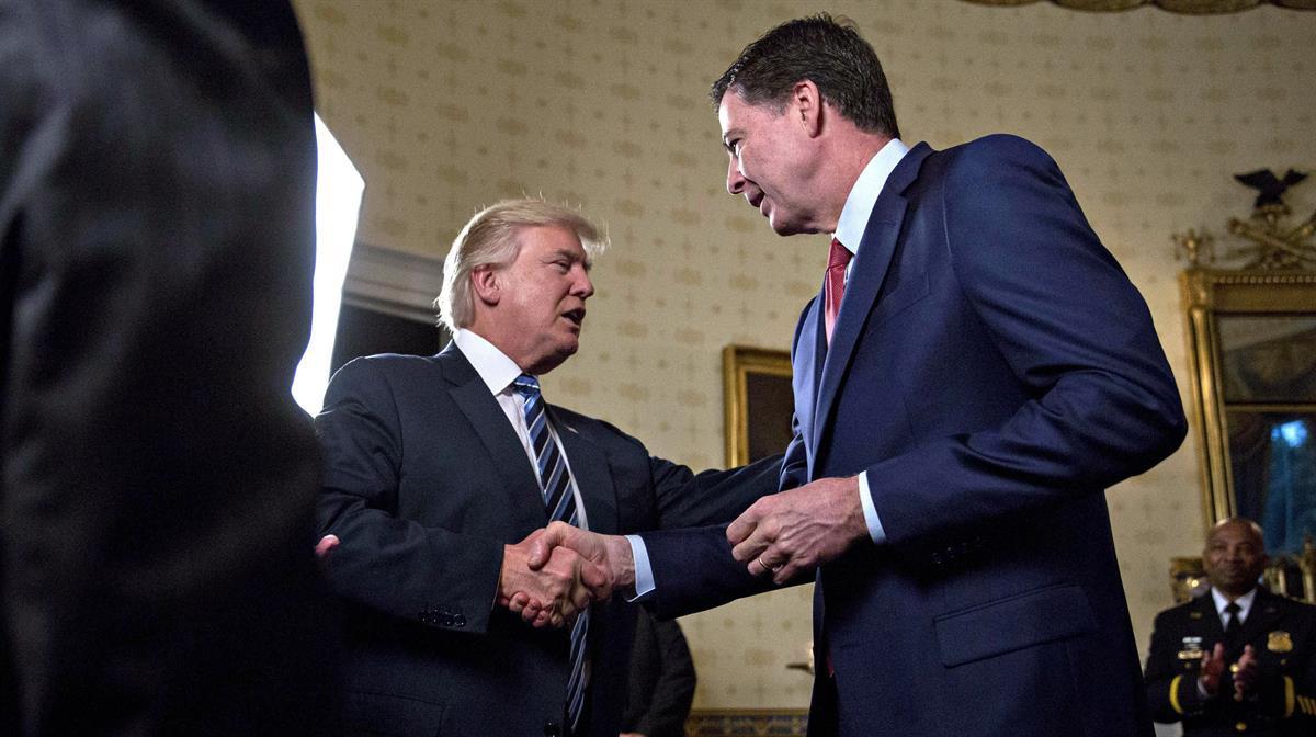 President Donald Trump shakes hands with James Comey, former director of the FBI, in the White House — Jan. 22, 2017. (Andrew Harrer-Pool/Getty Images)