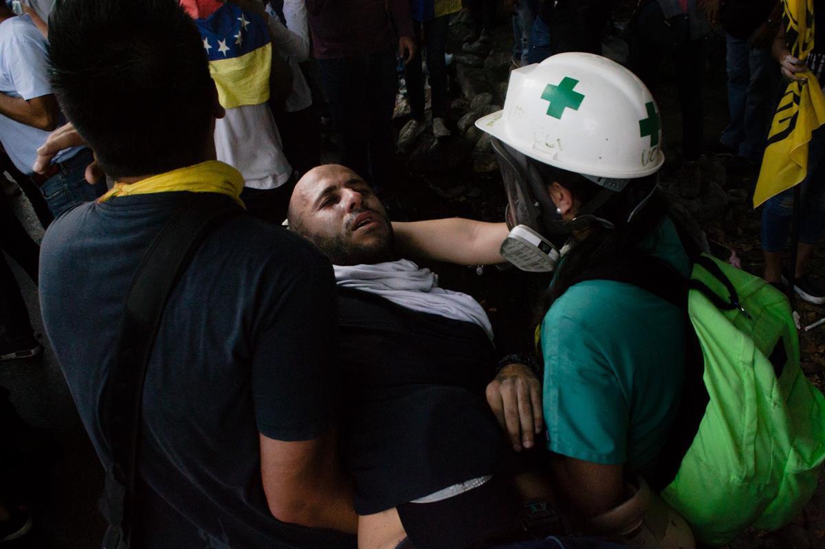 An injured protester being treated by volunteers (Photo by: <a href=
