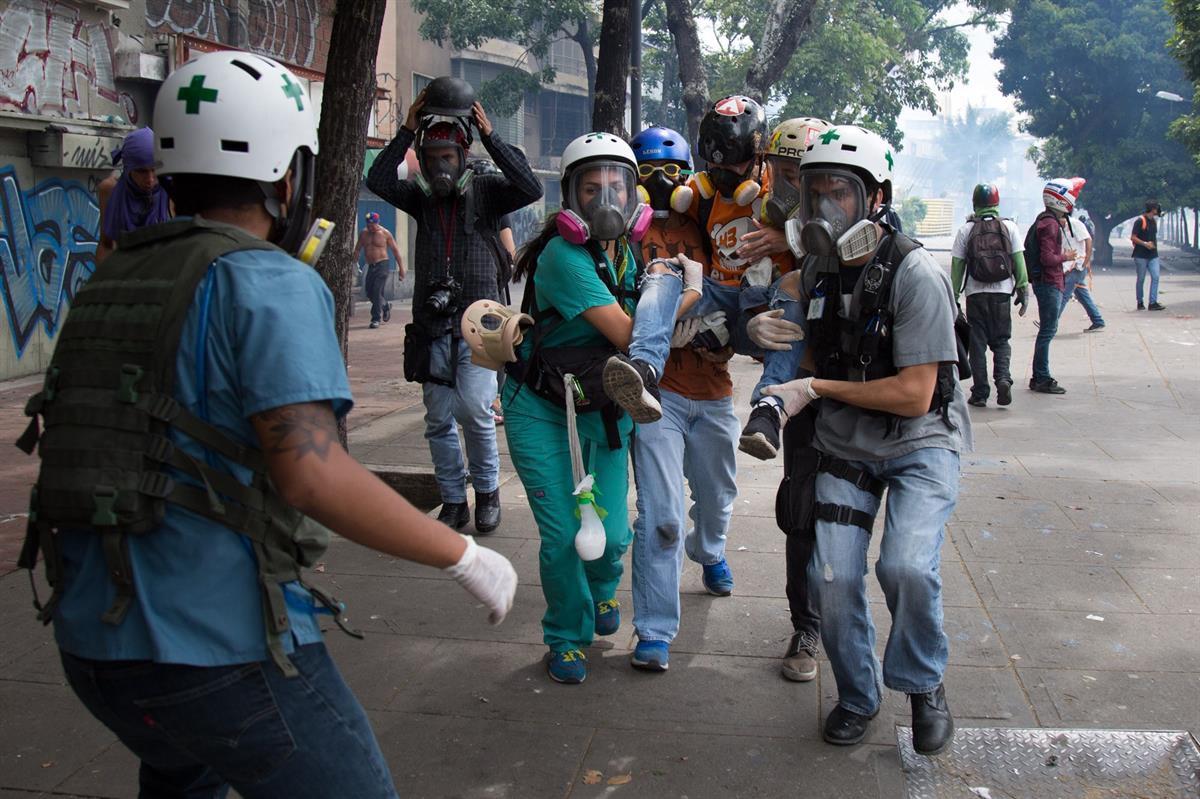 The Green Helmets carrying an injured patient for treatment (Photo by: <a href=