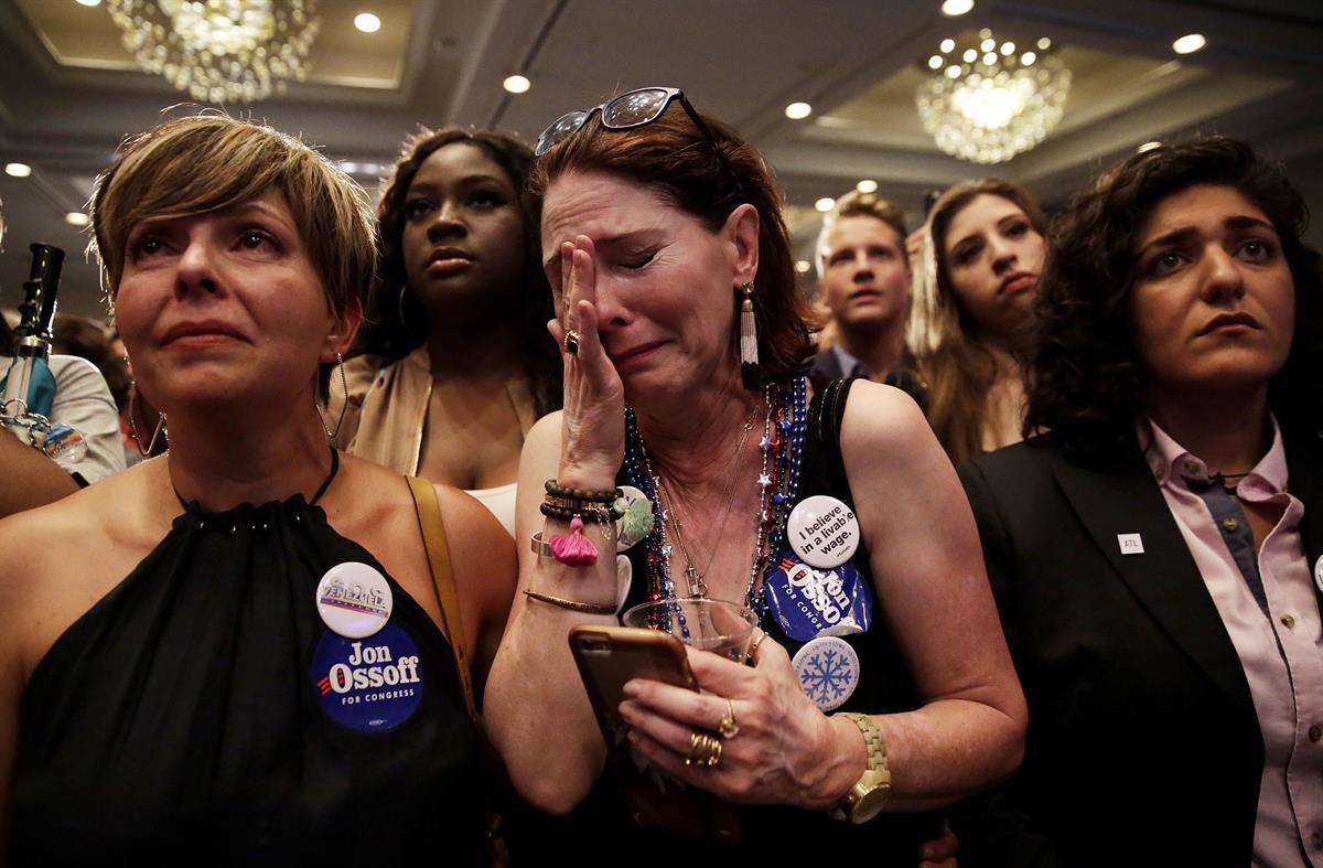 Supporter Jan Yanes, center, cries as Democratic candidate for 6th congressional district Jon Ossoff concedes to Republican Karen Handel at his election night party in Atlanta, Tuesday, June 20, 2017. (AP Photo/David Goldman)
