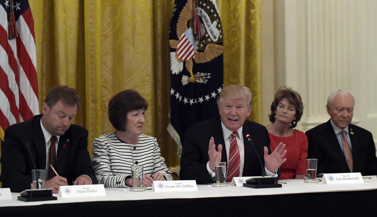 The day McConnell delayed the health care vote, President Donald Trump met with Republican senators in the White House. Seated with him, from left, are Dean Heller (R-NV), Susan Collins (R-ME), Lisa Murkowski (R-AK), and Sen. Orrin Hatch, R-Utah — Tuesday, June 27, 2017 (AP/Susan Walsh)