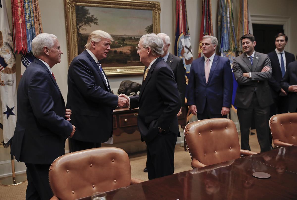 President Donald Trump shakes hands with Senate Majority Leader Mitch McConnell (R-KY), center. Also in the room are from left, Vice President Mike Pence, Senate Majority Whip John Cornyn (R-TX), House Majority Leader Kevin McCarthy (R-CA), House Speaker Paul Ryan (R-WI)., and Senior adviser to President Donald Trump Jared Kushner — June 6, 2017 (AP)