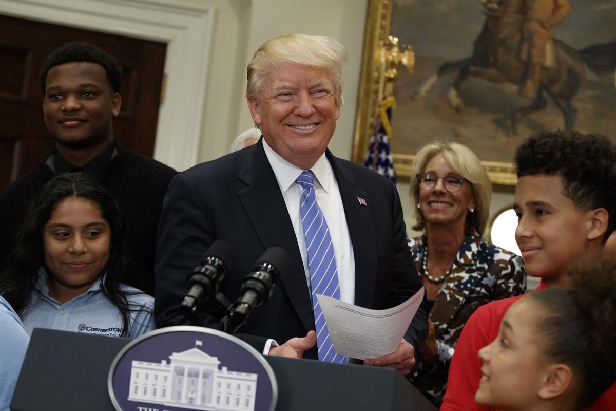 President Donald Trump, accompanied by Education Secretary Betsy DeVos, arrives to speak during a school choice event in the Roosevelt Room of the White House — May 3, 2017. (AP/Evan Vucci)
