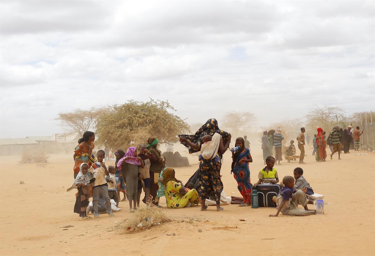 Newly arrived Somali refugees wait outside a UNHCR processing center at the Ifo refugee camp outside Dadaab, eastern Kenya, 100 kilometers (62 miles) from the Somali border. Human-induced climate change contributed to low rain levels in East Africa in 2011, making global warming one of the causes of Somalia’s famine and the tens of thousands of deaths that followed, a new study has found — Aug. 5, 2011 (AP Photo/Jerome Delay)