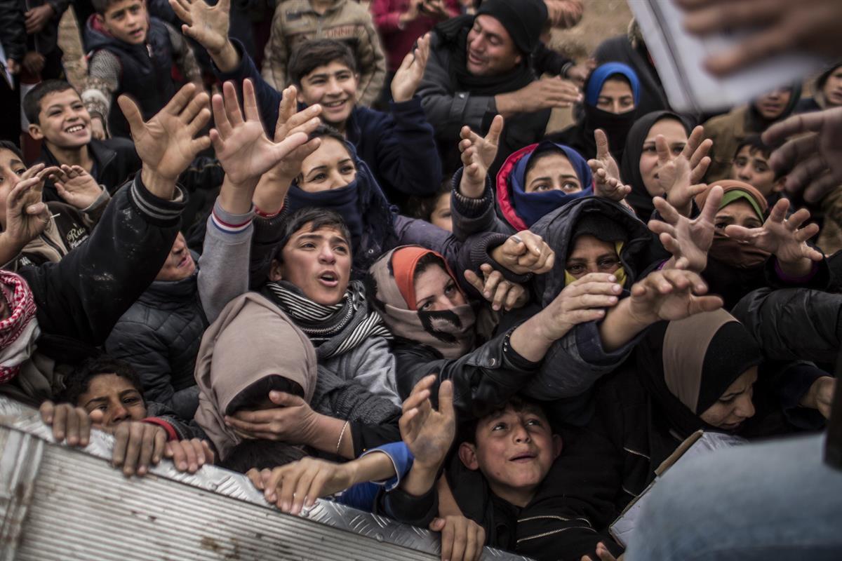 Iraqi displaced people plead for food during an aid distribution in Khazer camp for the displaced in Iraqi Kurdistan, Iraq — Dec. 17, 2016 (AP/Manu Brabo)