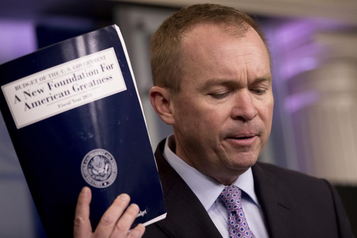 Budget Director Mick Mulvaney holds up a copy of President Donald Trump’s proposed fiscal 2018 federal budget — Tuesday, May 23, 2017. (AP Photo/Andrew Harnik)