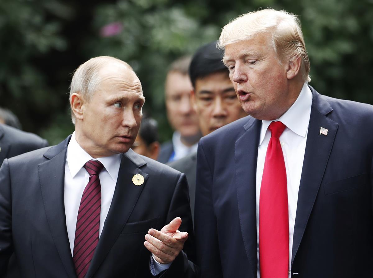U.S. President Donald Trump and Russia’s President Vladimir Putin talk during the family photo session at the APEC Summit in Danang, Vietnam, Saturday, Nov. 11, 2017. (Jorge Silva/Pool Photo via AP)