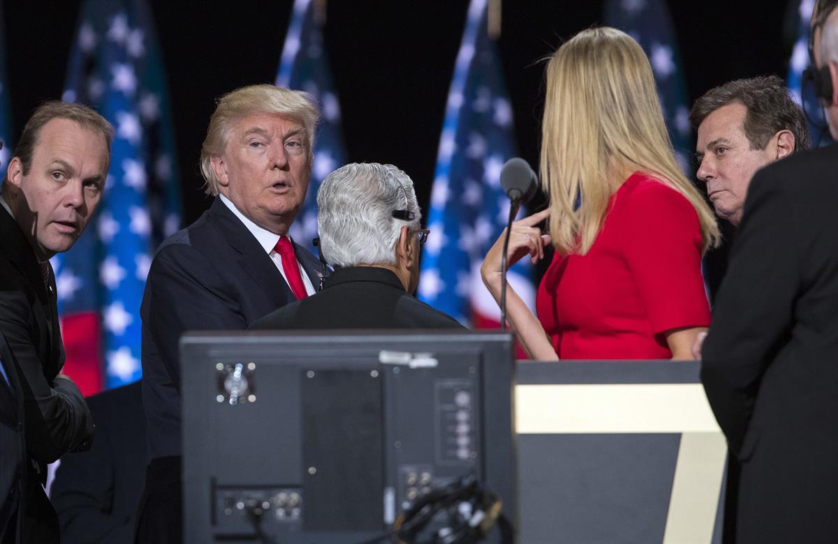 In this July 21, 2016, photo, then-Republican presidential candidate Donald Trump, his daughter Ivanka Trump, then-campaign manager Paul Manafort, right, and Rick Gates, left, on stage during a walk through at the Republican National Convention, Thursday, July 21, 2016, in Cleveland. (AP Photo/Evan Vucci)
