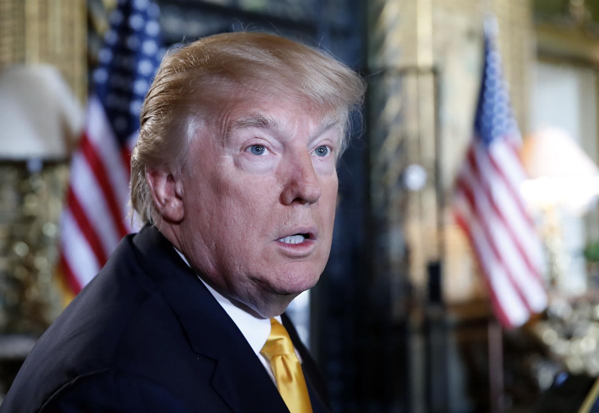 President Donald Trump speaks to the media before speaking with members of the armed forces via video conference at his private club, Mar-a-Lago, on Thanksgiving in Palm Beach, Fla. (AP Photo/Alex Brandon, File)