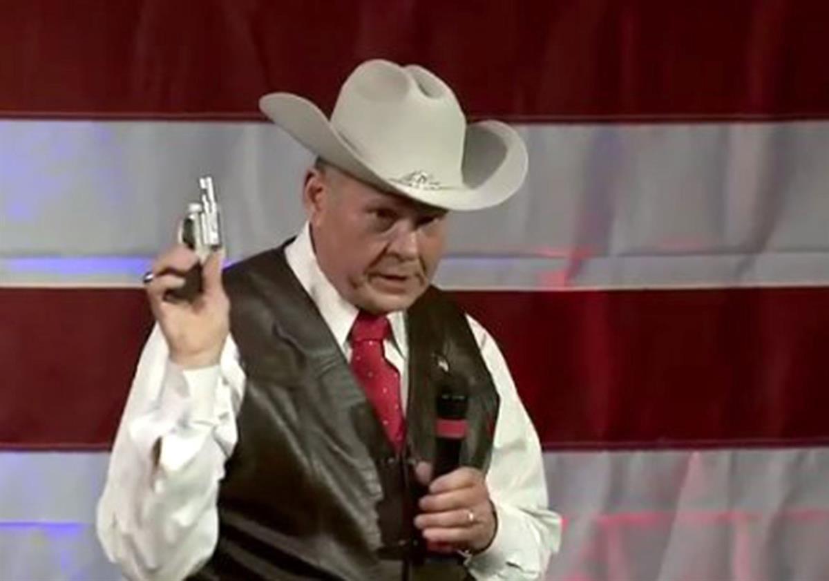 Alabama Senate Candidate Roy Moore brandishes a firearm at a campaign rally in Fairhope, Alabama