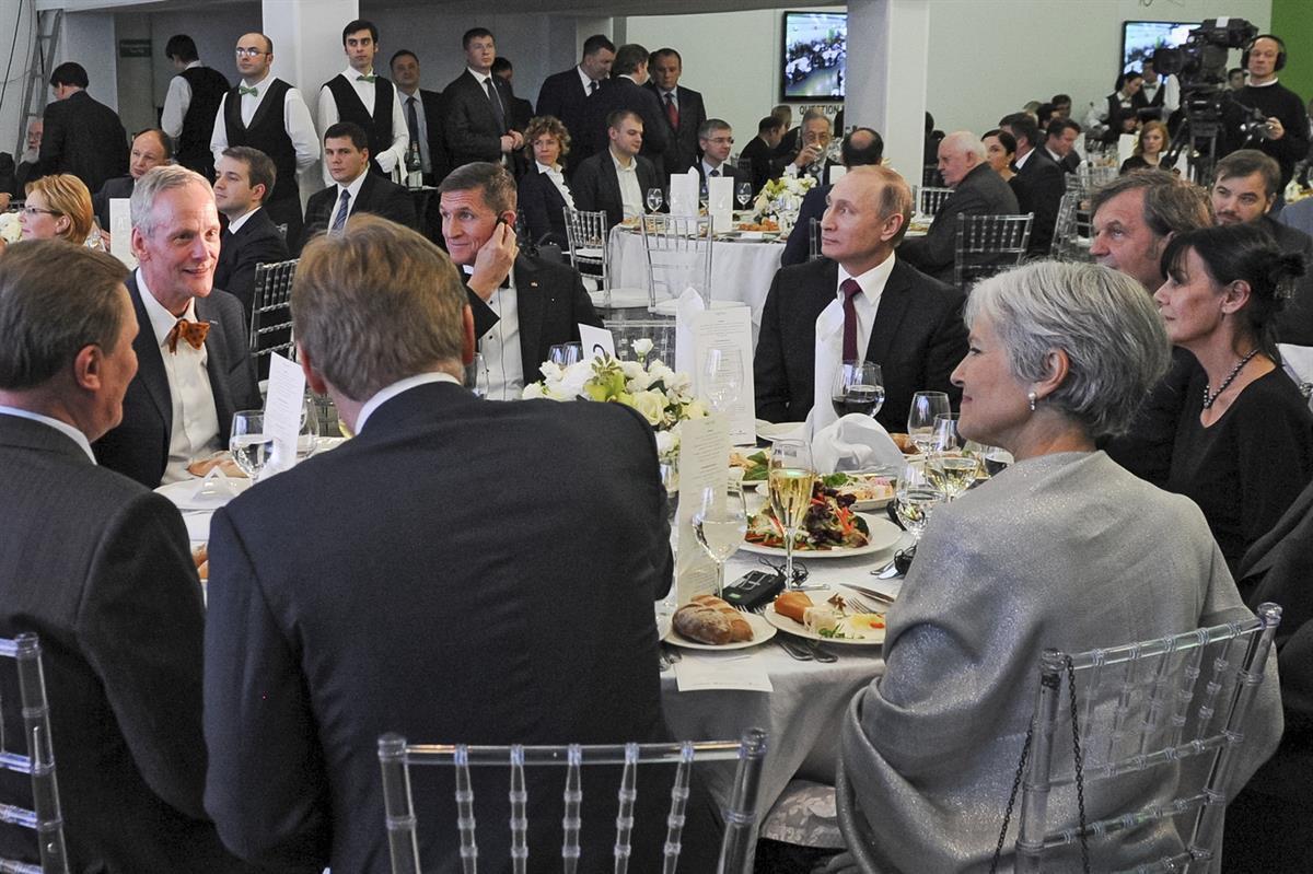 Russian President Vladimir Putin, center right, with retired U.S. Lt. Gen. Michael T. Flynn, center left. Michael Flynn was in attendance of the 10th anniversary of RT (the Russian government’s propaganda network). Flynn acknowledged that he was paid to attend the event. And yes, that is former Green Party candidate Jill Stein — Dec. 10, 2015 (Mikhail Klimentyev/Sputnik, Kremlin Pool Photo via AP)