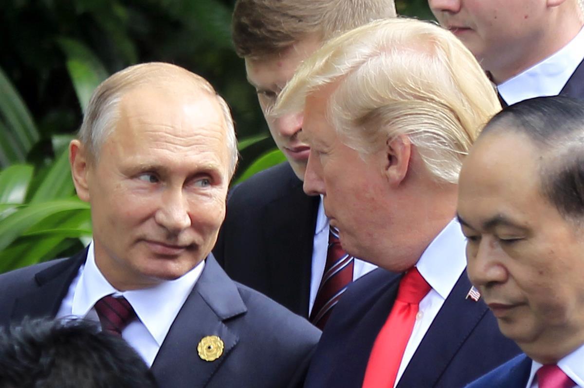 Russian President Vladimir Putin, left, and U.S. President Donald Trump talk as they arrive for the family photo session during the Asia-Pacific Economic Cooperation (APEC) Summit in Danang, Vietnam, Saturday, Nov. 11, 2017. (AP Photo/Hau Dinh)