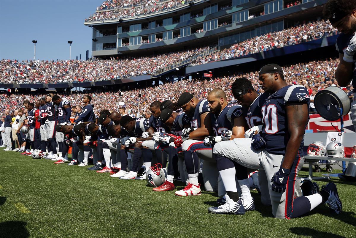 Several New England Patriots players kneel during the national anthem before an NFL football game against the Houston Texans, Sunday, Sept. 24, 2017, in Foxborough, Mass. (AP Photo/Michael Dwyer)