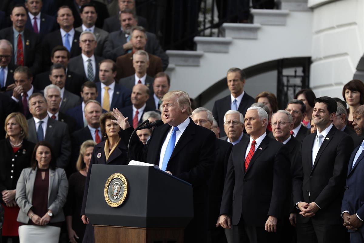 President Donald Trump, with Republican leaders behind him, speaks during the tax bill passage event on the South Lawn of the White House — Wednesday, Dec. 20, 2017 (AP Photo/Evan Vucci)