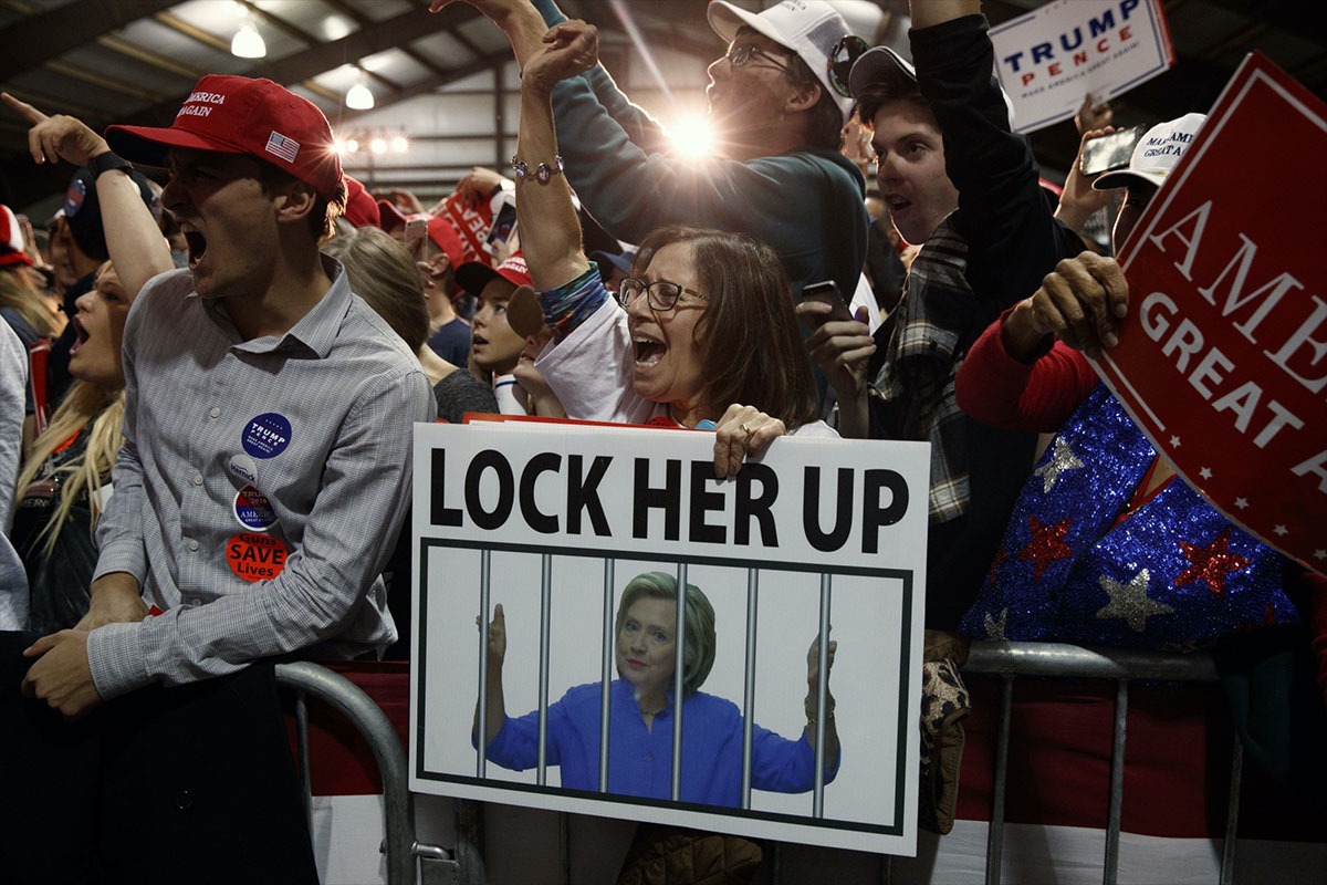 Supporters of Donald Trump, one holding a sign that reads, “LOCK HER UP,” cheer during a campaign rally in Leesburg, Va. Trump?—?Monday, Nov. 7, 2016 (AP Photo/ Evan Vucci)