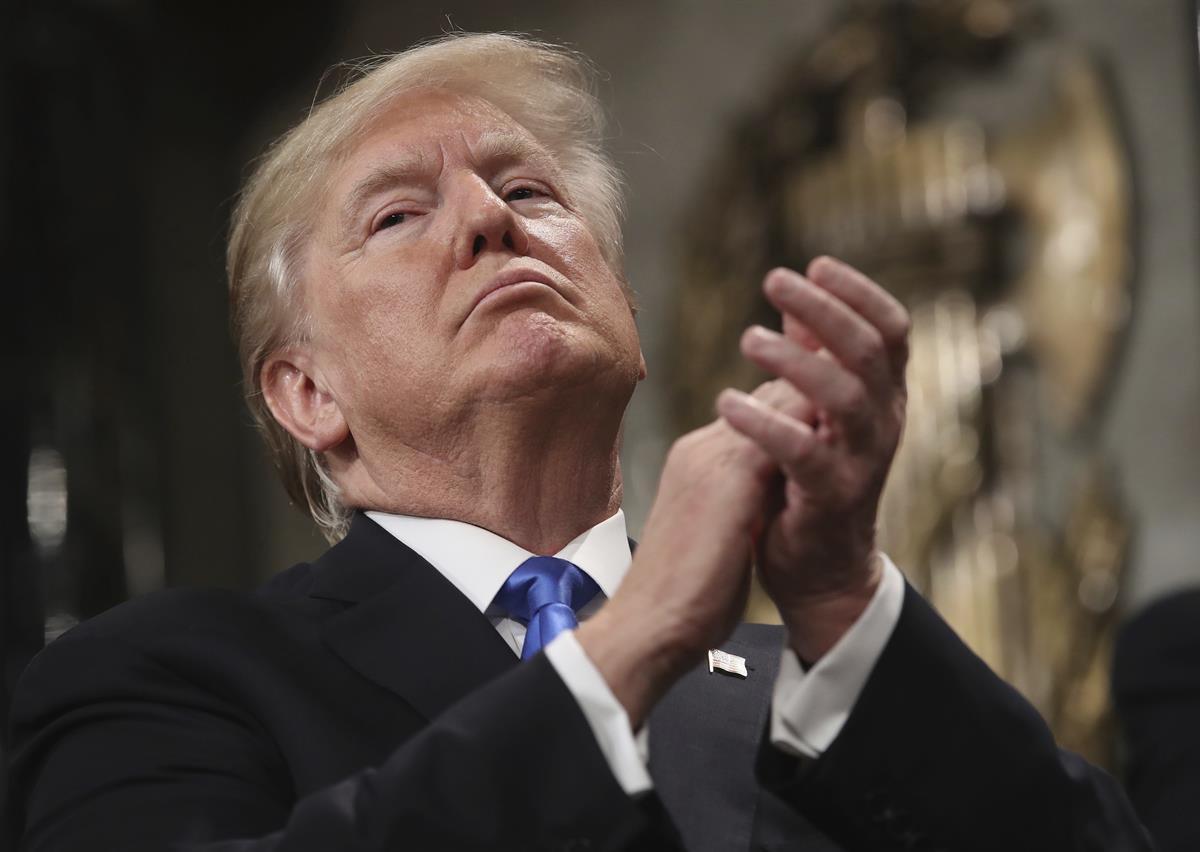 President Donald Trump applauds himself as he finishes his first State of the Union address — Tuesday, Jan. 30, 2018 in Washington. (Win McNamee/Pool via AP)
